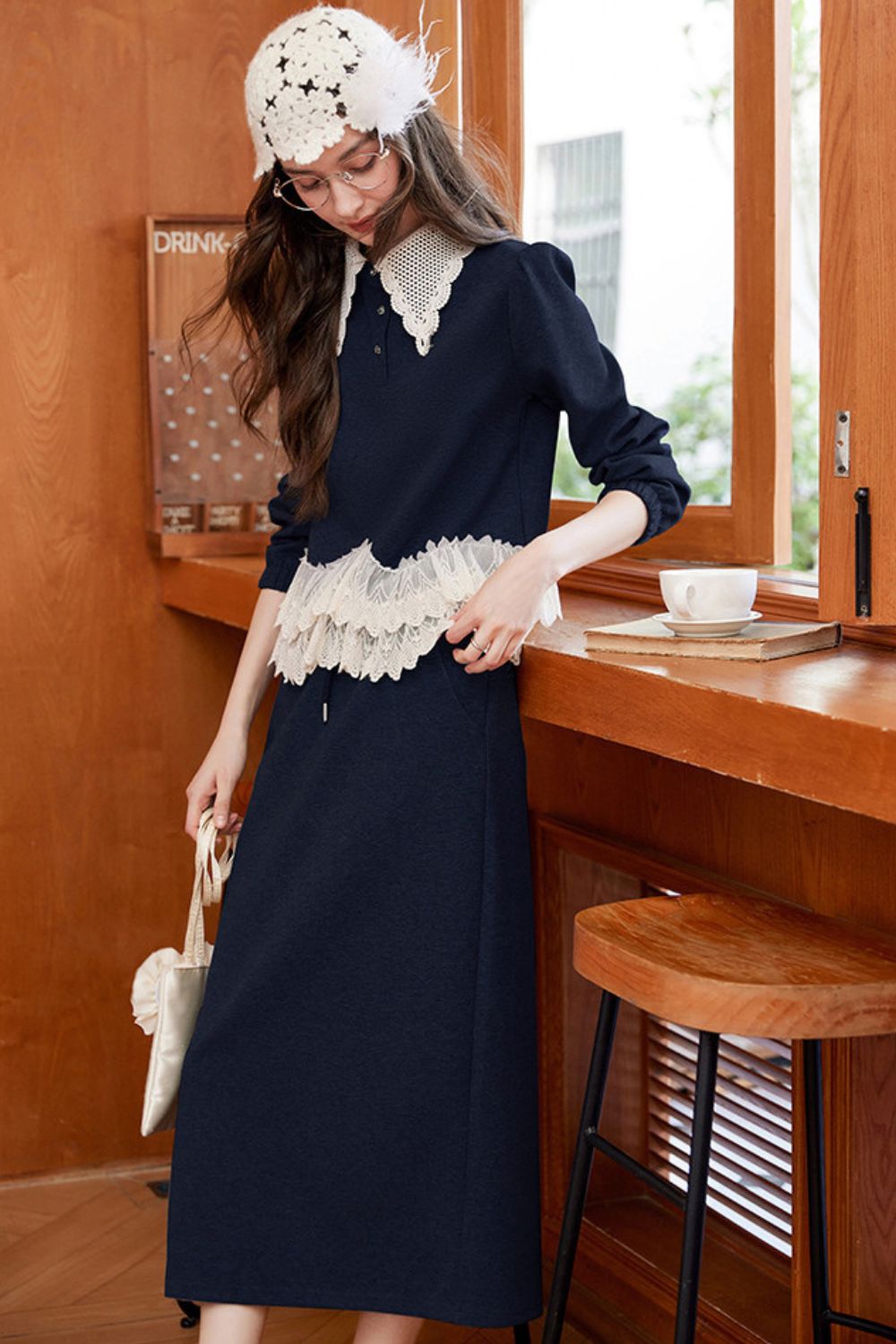 Side view of navy blue lace-trimmed top with long skirt and crochet hat
