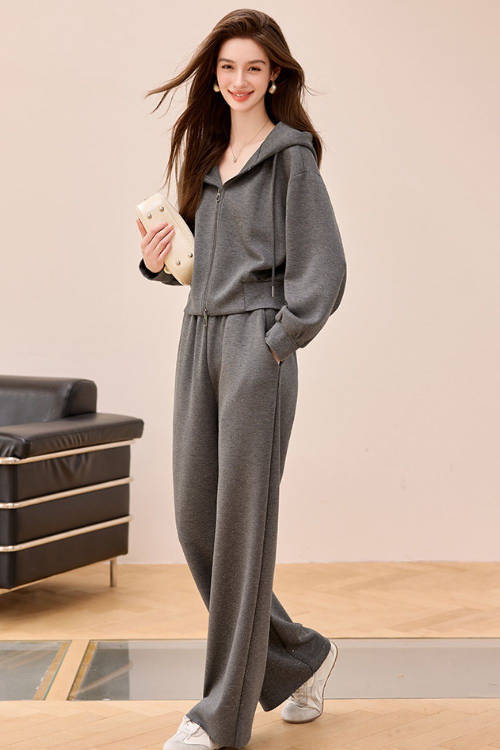 Standing model in gray wide-leg jumpsuit with side pockets and relaxed fit