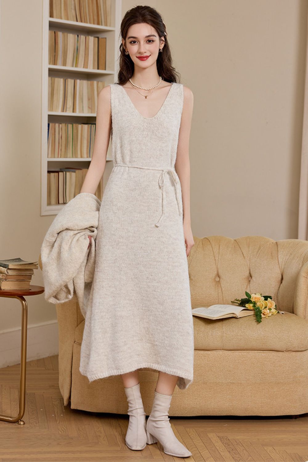 Sleeveless cream knit dress shown without cardigan