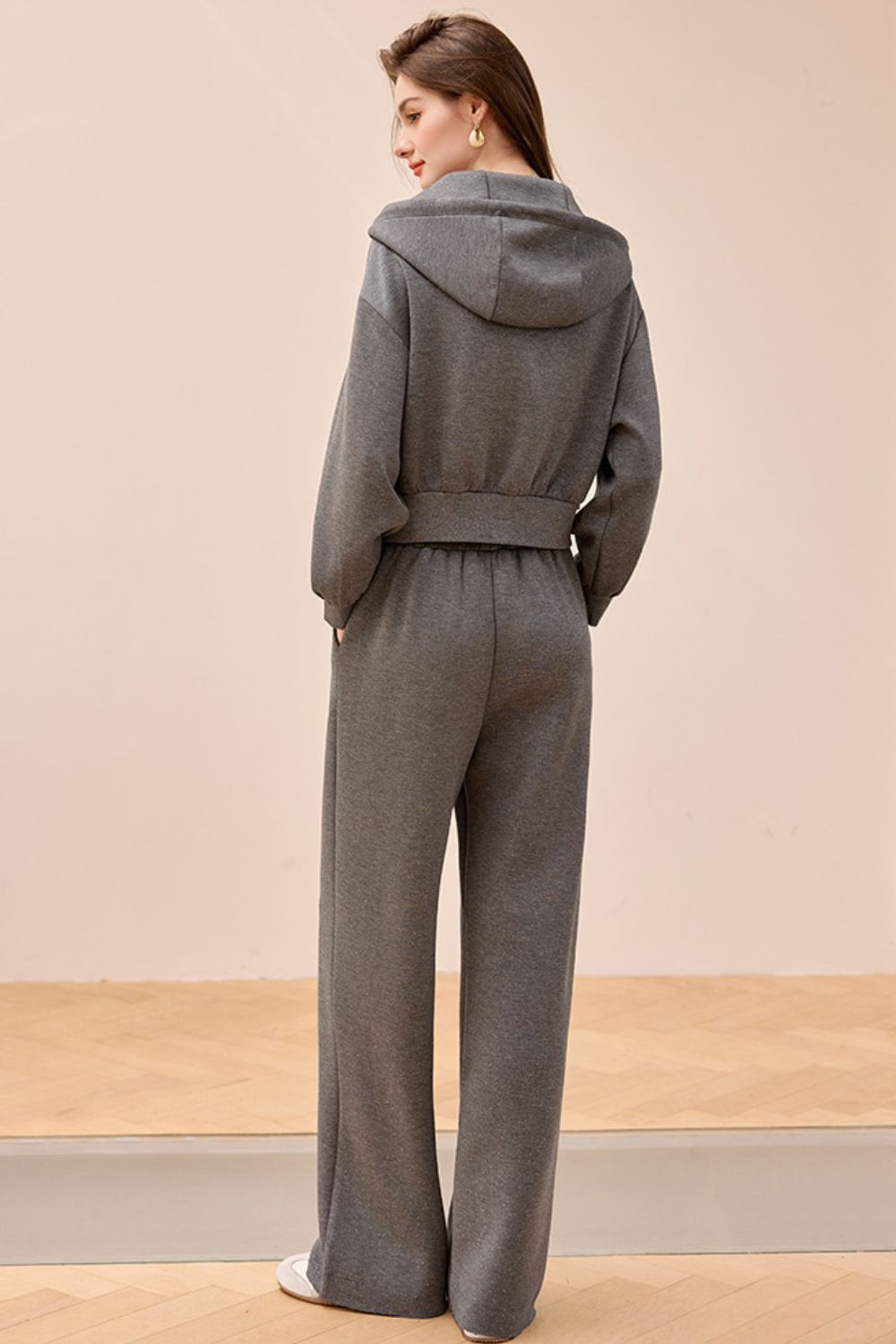 Back view of gray wide-leg jumpsuit with relaxed fit and straight cut