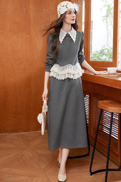 Model wearing gray lace-trimmed blouse with maxi skirt, holding a crochet bag