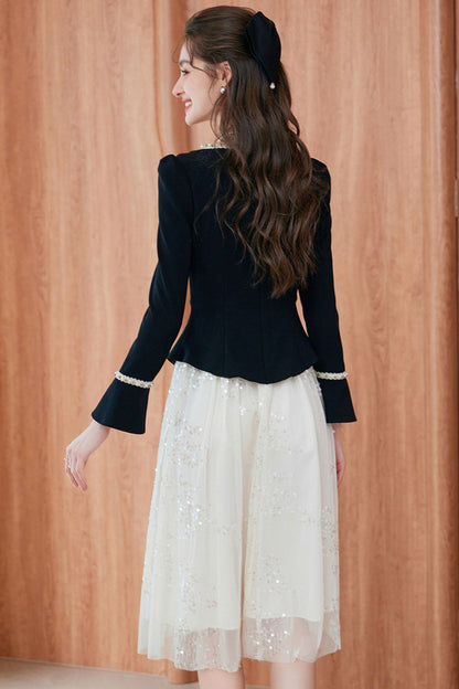 Back profile of outfit featuring black blazer and white embroidered skirt