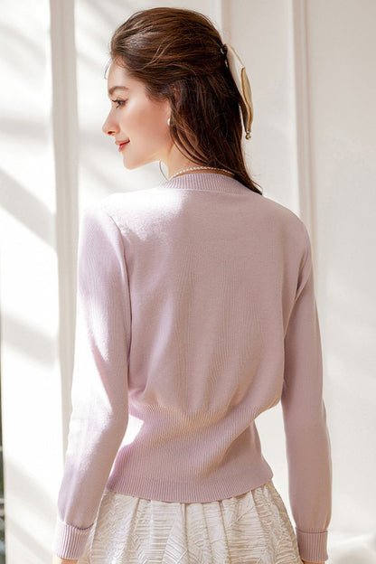 Back view of light purple cardigan paired with white skirt