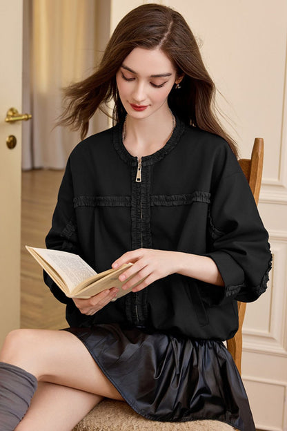 Seated view of black jacket with skirt